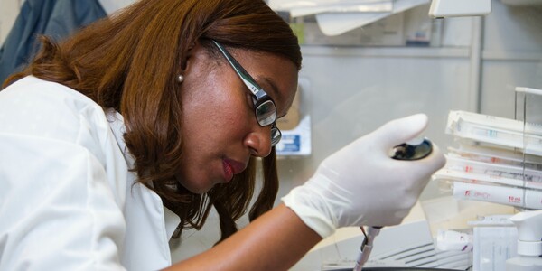 researcher uses a pipette