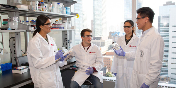 researchers talk in a lab