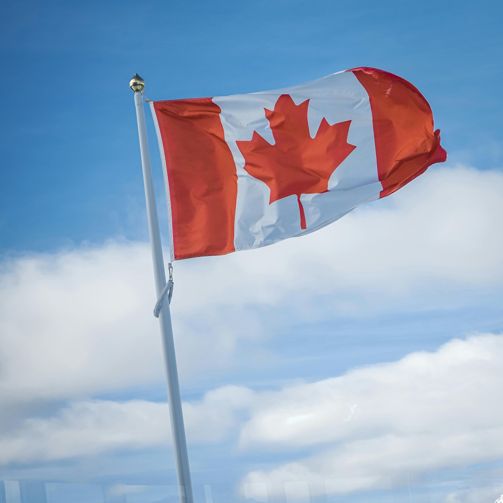 The Canadian flag flies at full mast