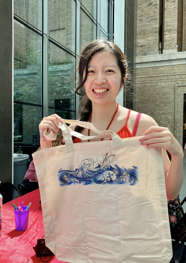 Celestine Hong proudly displays hand-drawn art work she created at the Museum of Fine Arts in Boston.